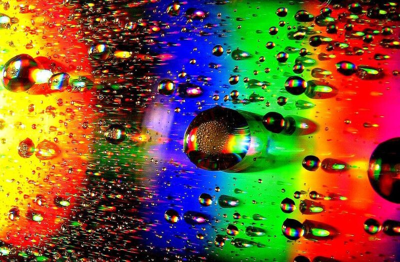 Colorful water droplets on rainbow surface
