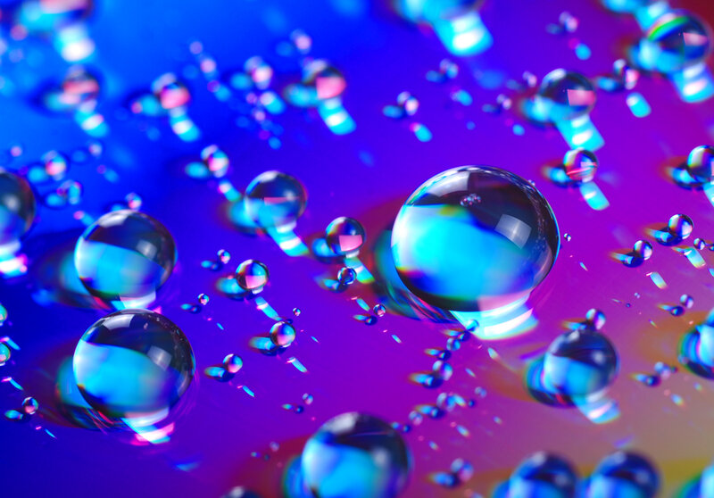 Colorful water droplets on vibrant surface