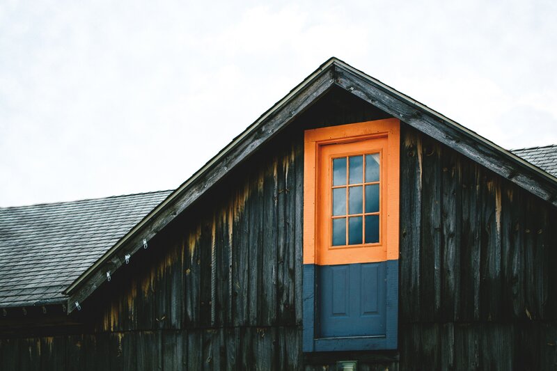 Colorful window on a wooden barn