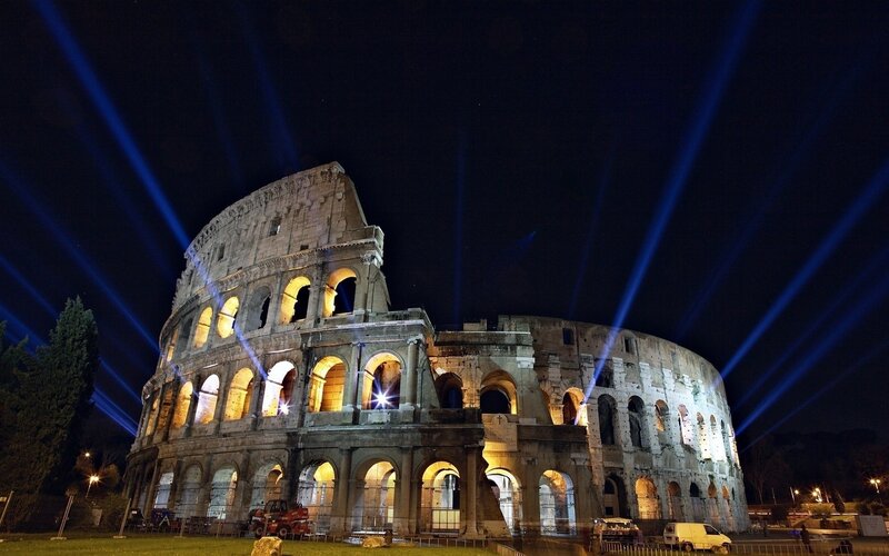 Colosseum at night with laser lights