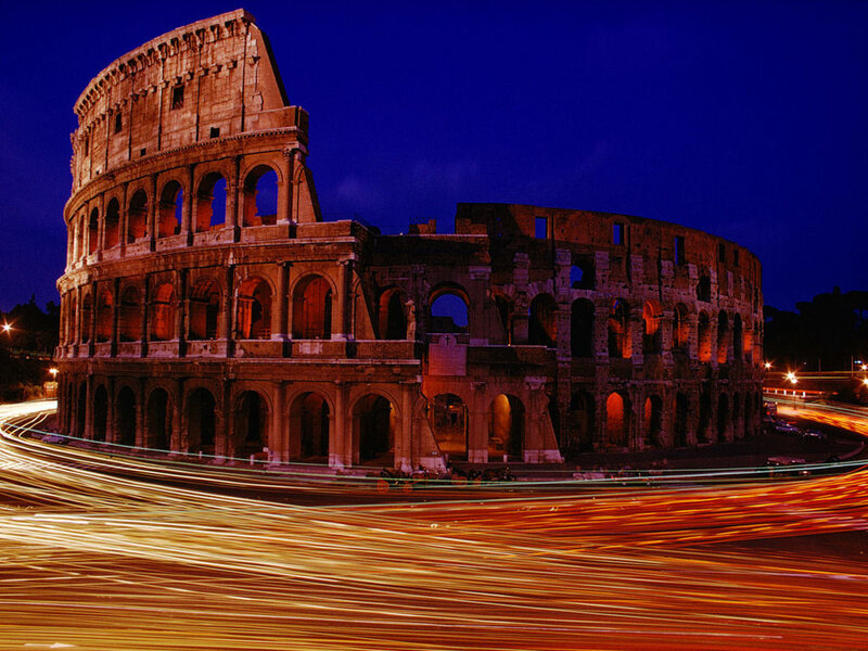 Colosseum at night with light trails