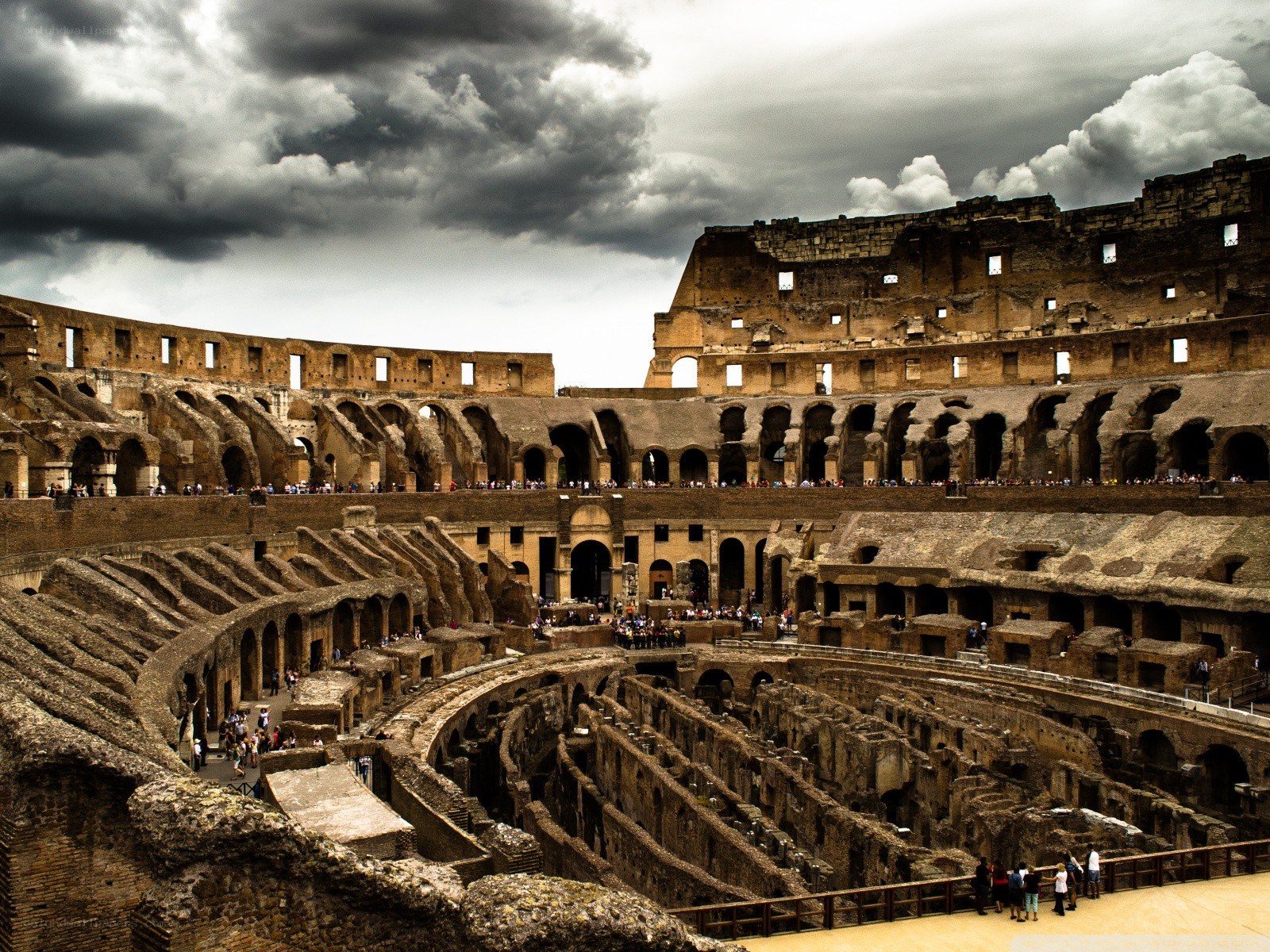 Colosseum interior under stormy sky