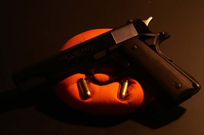 Colt pistol on orange cushion