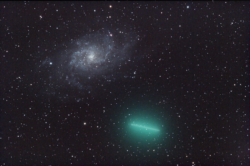 Comet and spiral galaxy in deep space