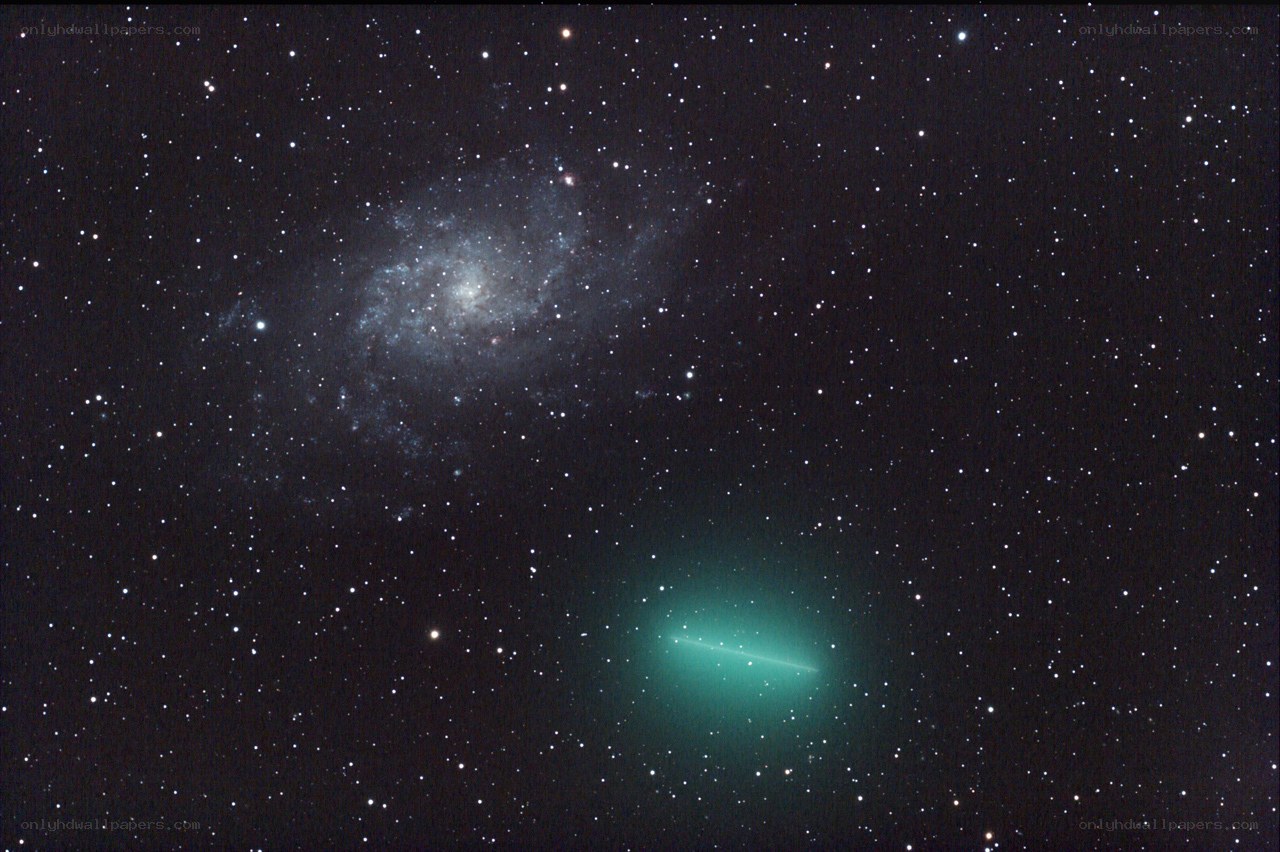 Comet and spiral galaxy in deep space