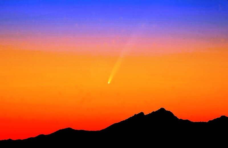 Comet over mountain silhouette