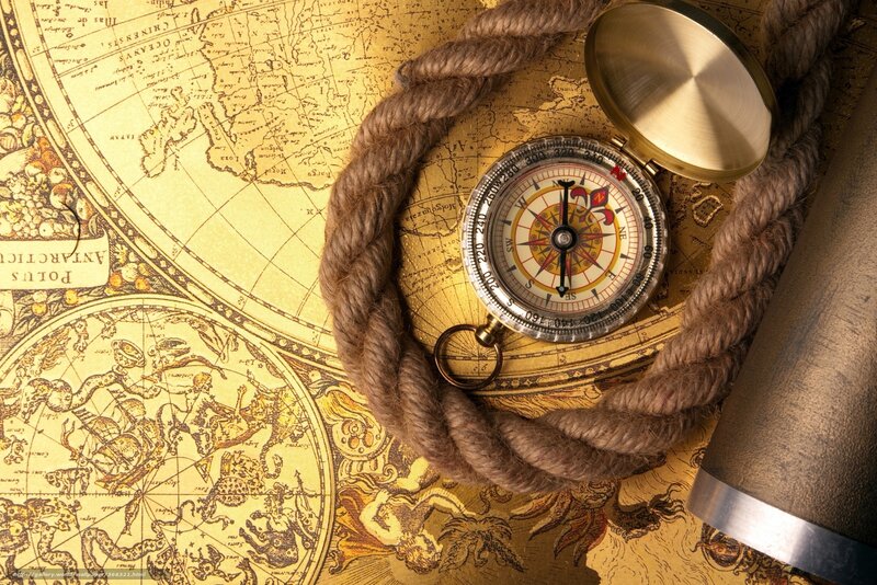 Compass on old map with rope