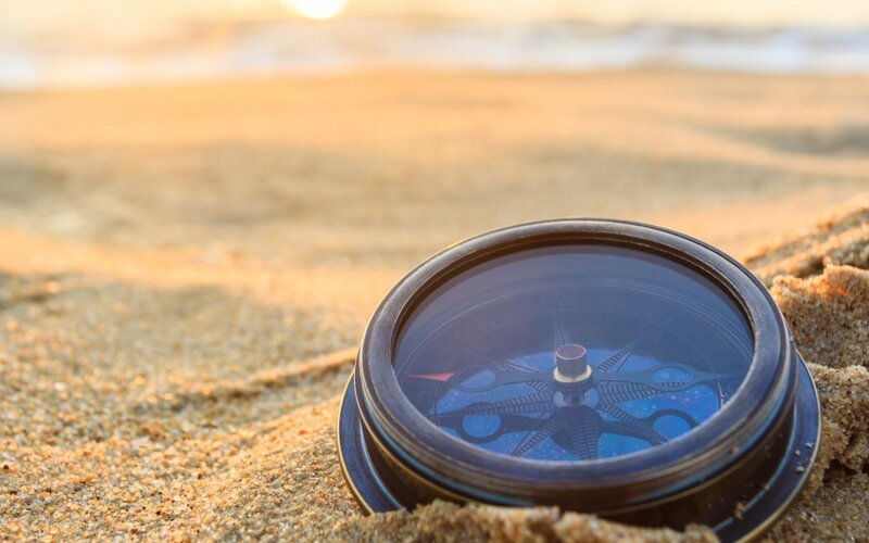 Compass on Sandy Beach — Brown