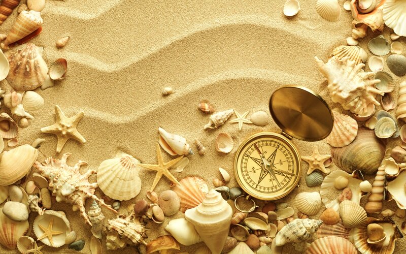 Compass on Sandy Beach