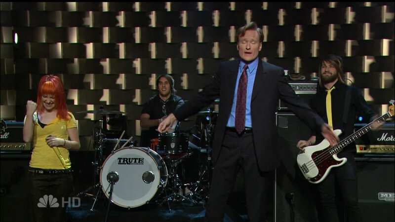 Conan O'Brien on stage with band
