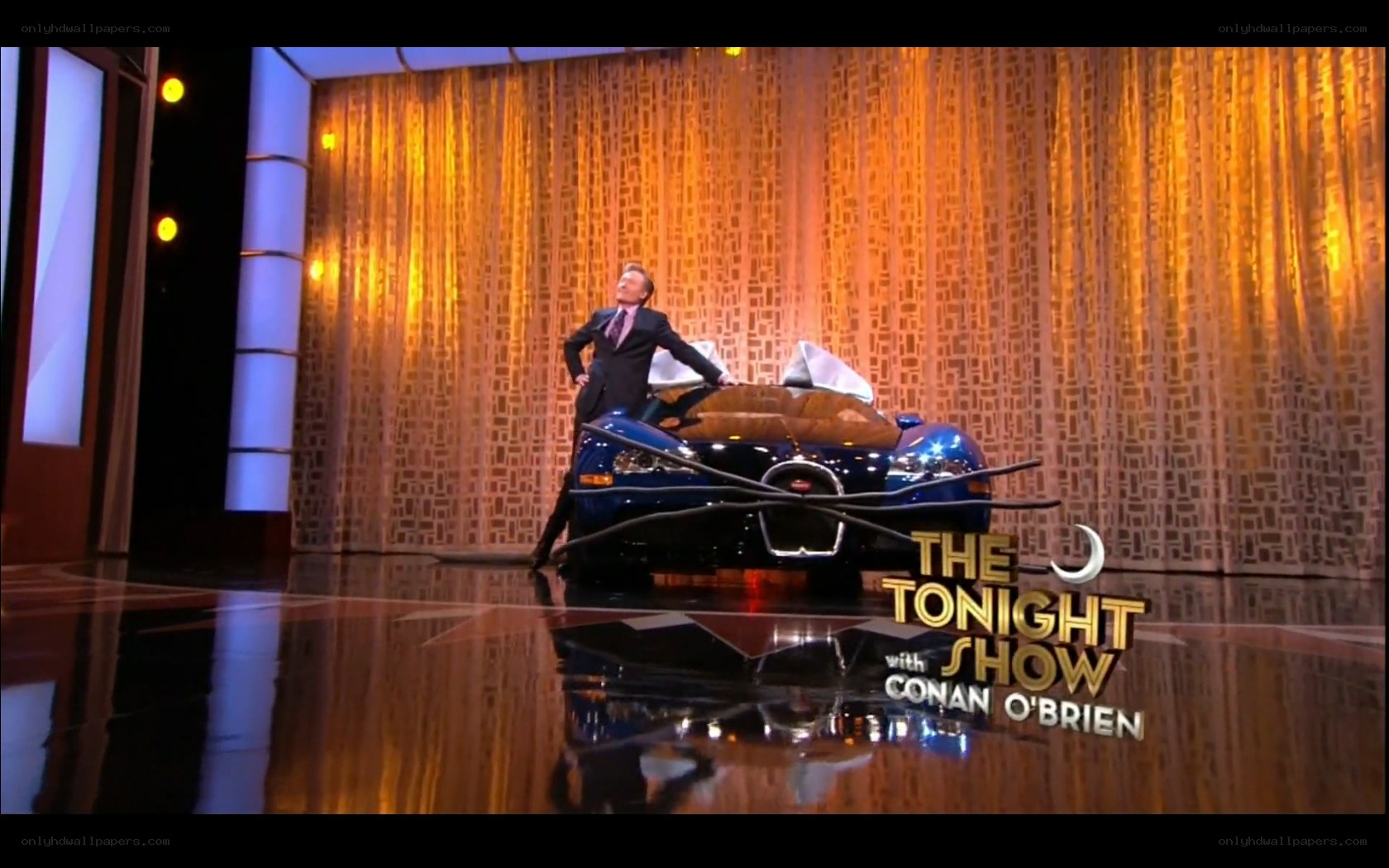 Conan O'Brien on stage with car