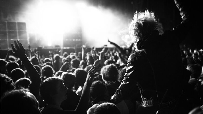 Concert crowd with raised hands