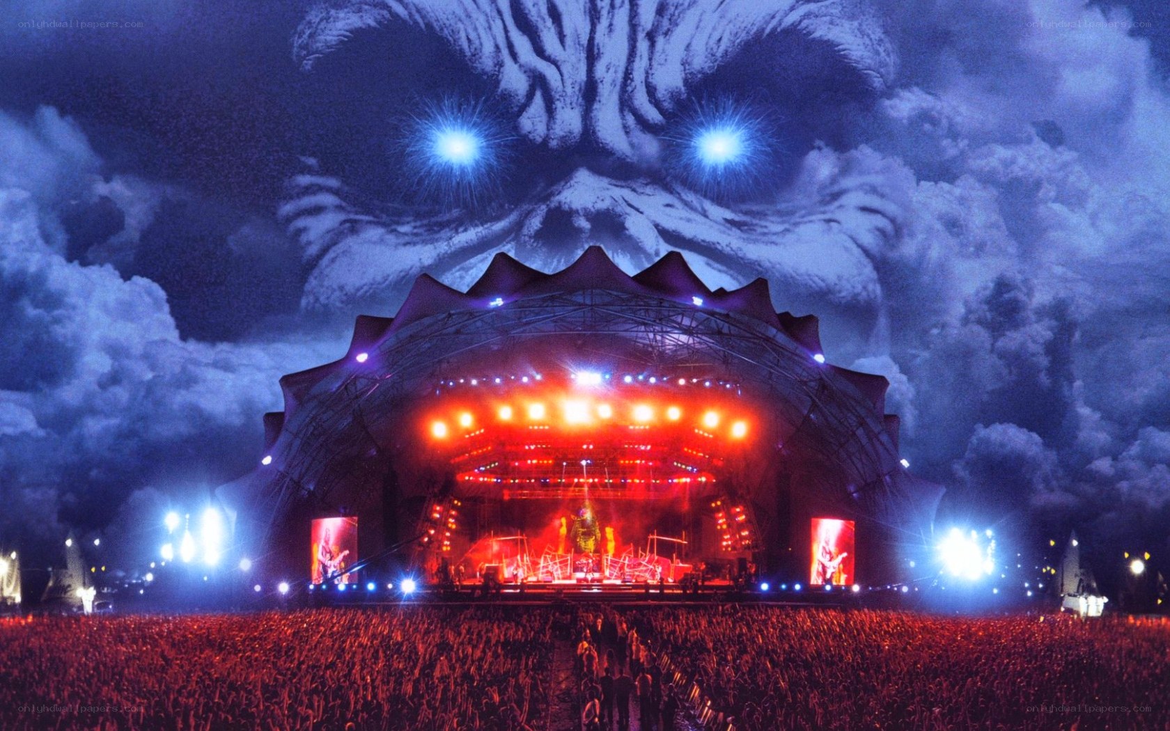 concert with giant face backdrop