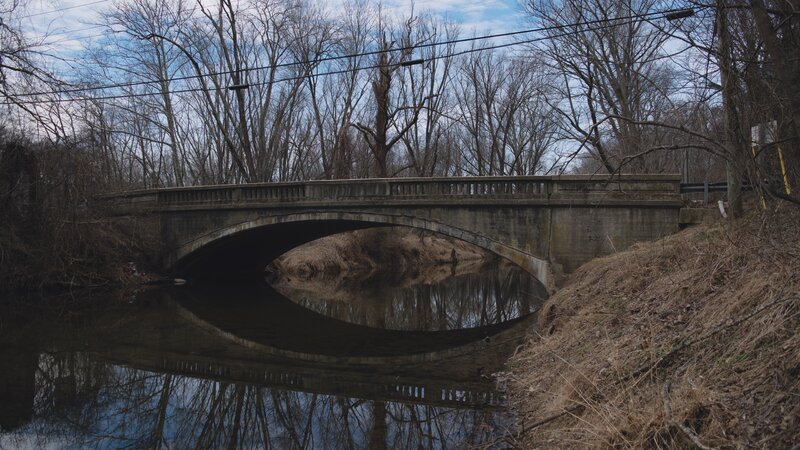 Concrete Bridge over River — Brown