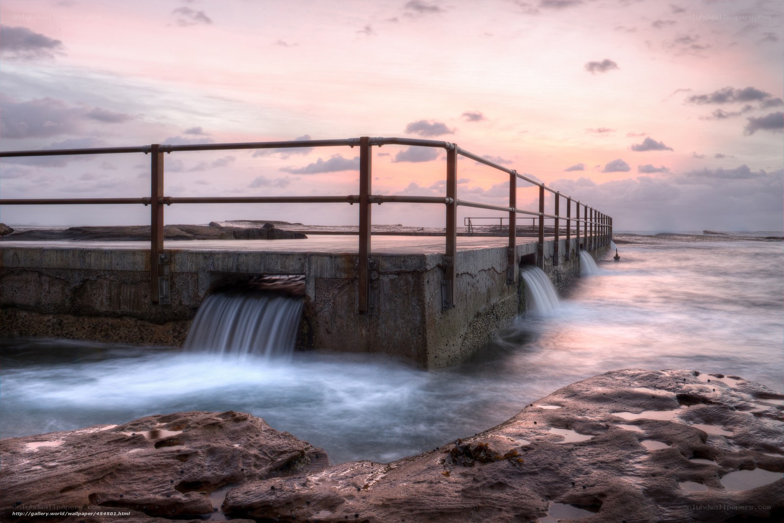 Concrete pier at sunset