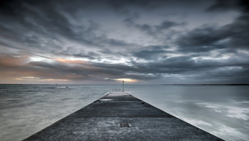 Concrete Pier Extending into Sea — Gray