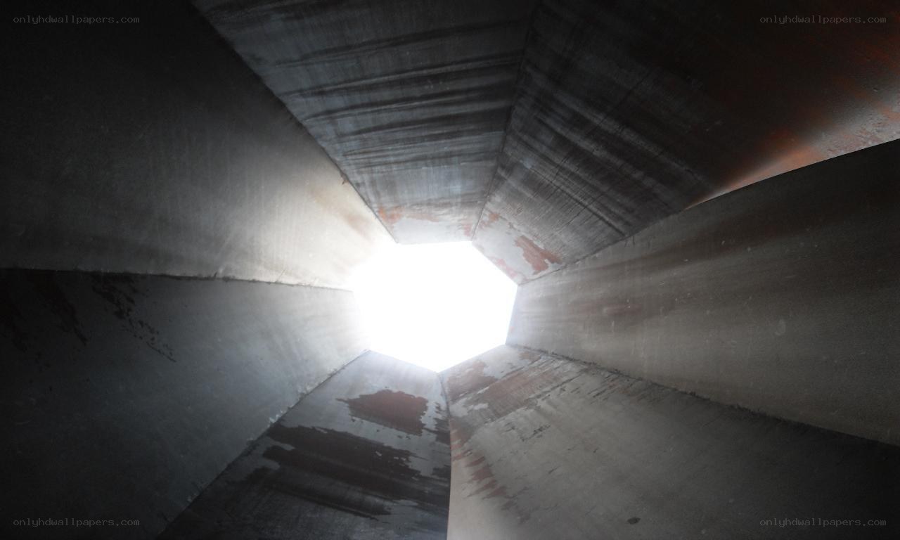 concrete tunnel with light at end