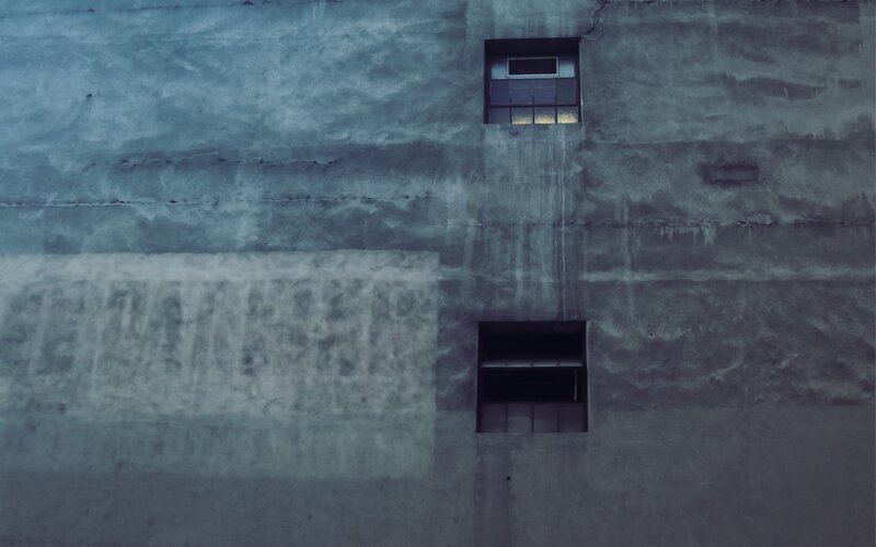 concrete wall with two windows