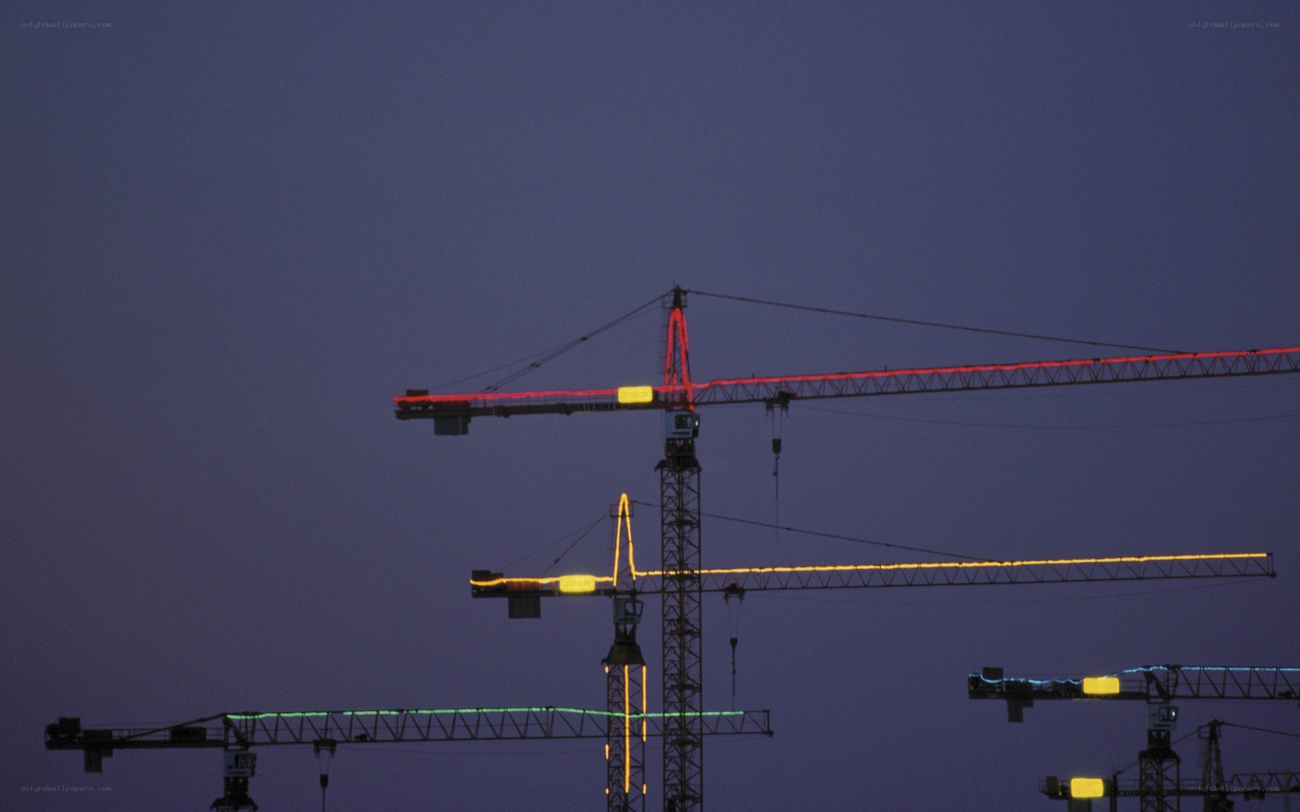 Construction cranes at dusk