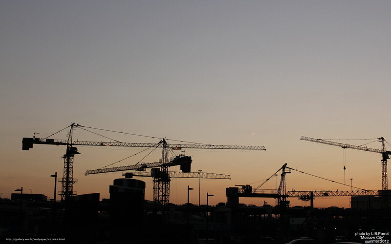 Construction cranes at dusk