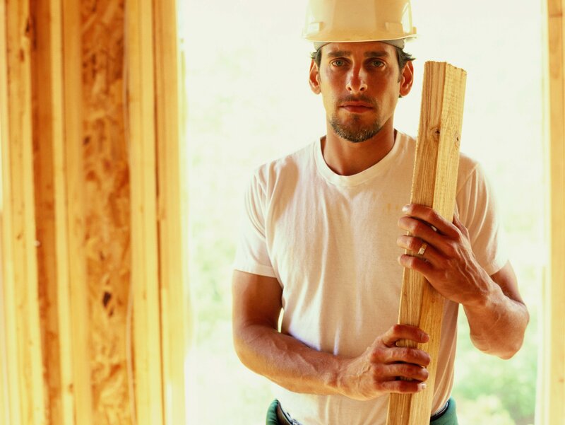 construction worker holding wood