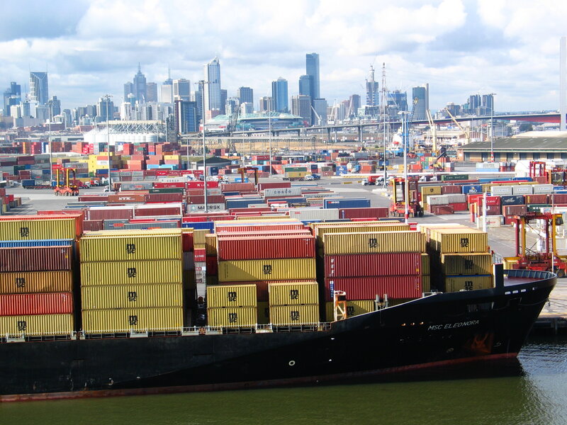 Container ship at port with city skyline