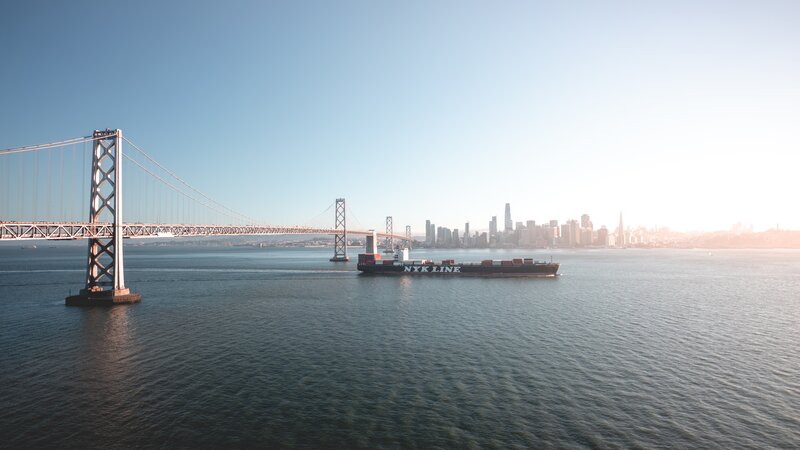 Container Ship under Bridge — Blue