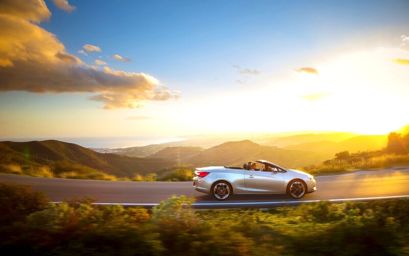 Convertible car on scenic road