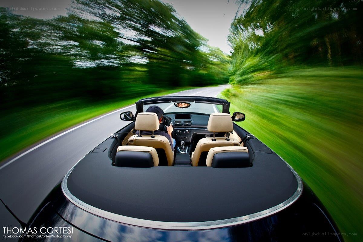 Convertible driving on a country road