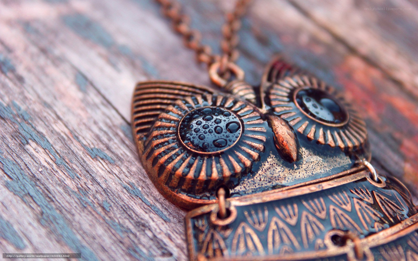copper owl pendant on wood