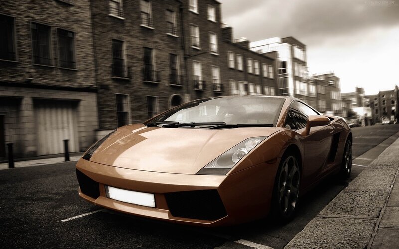 Copper sports car on city street