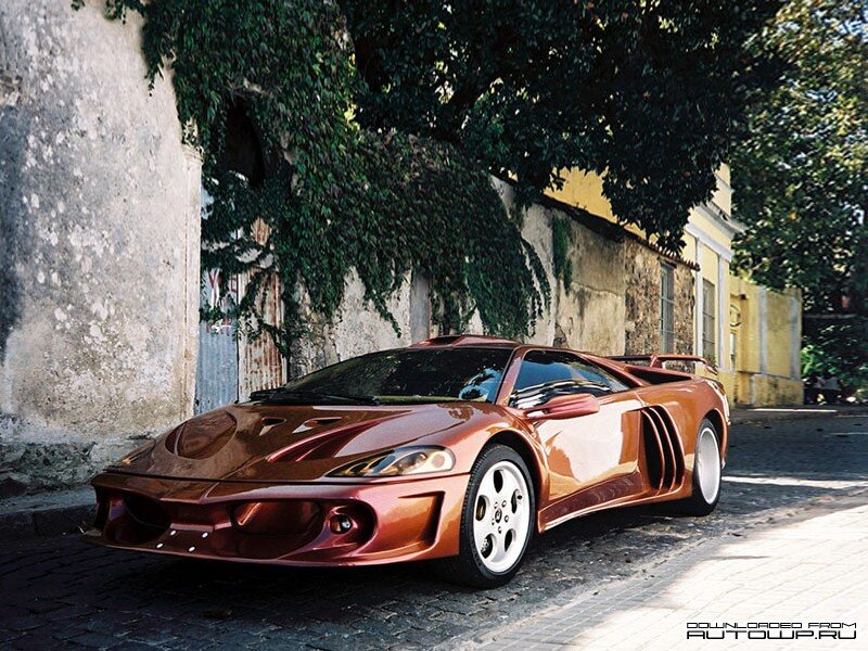 Copper sports car on cobblestone street