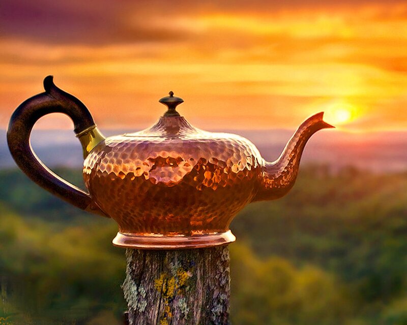 Copper teapot at sunset