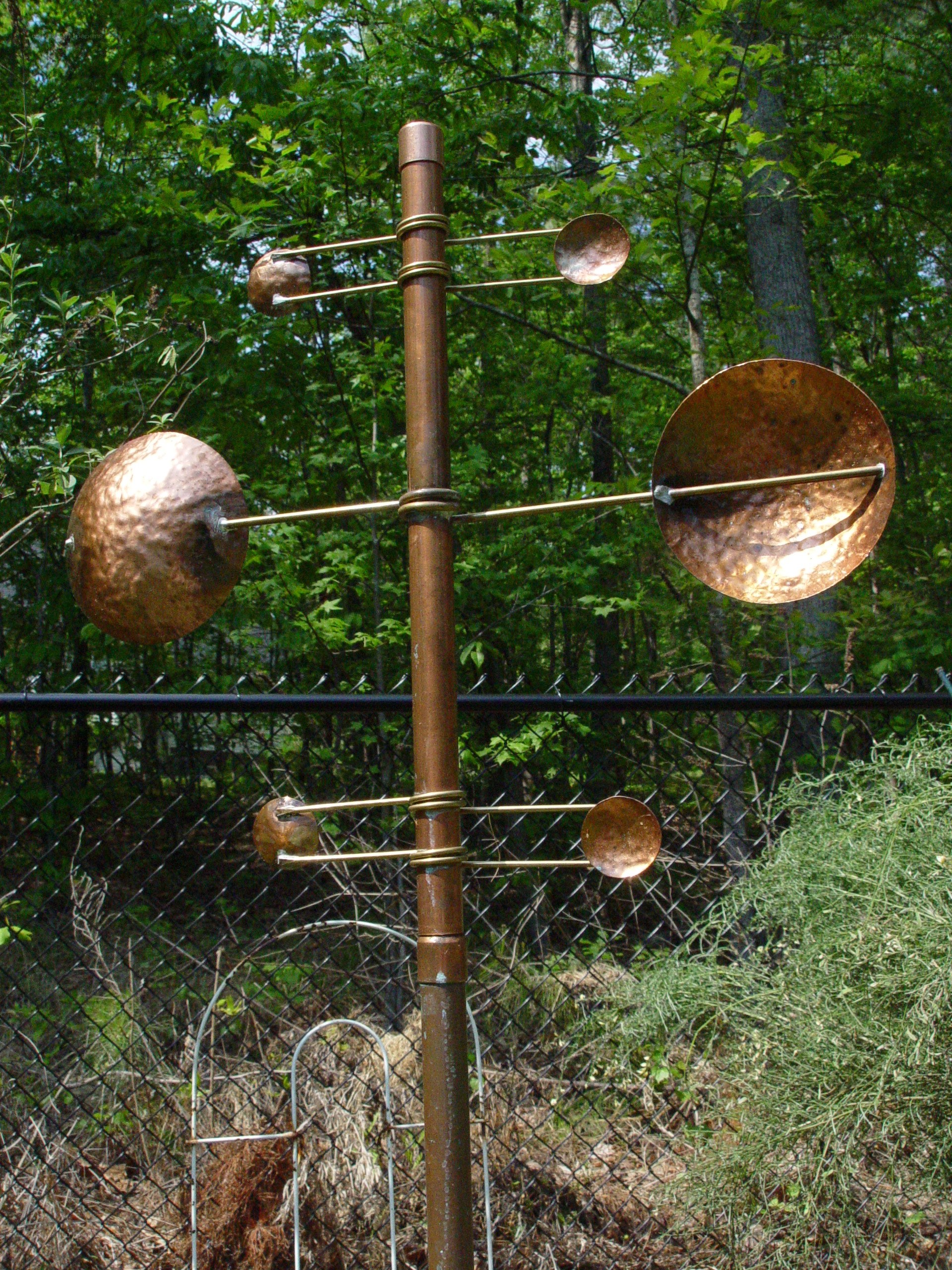 copper wind sculpture in garden