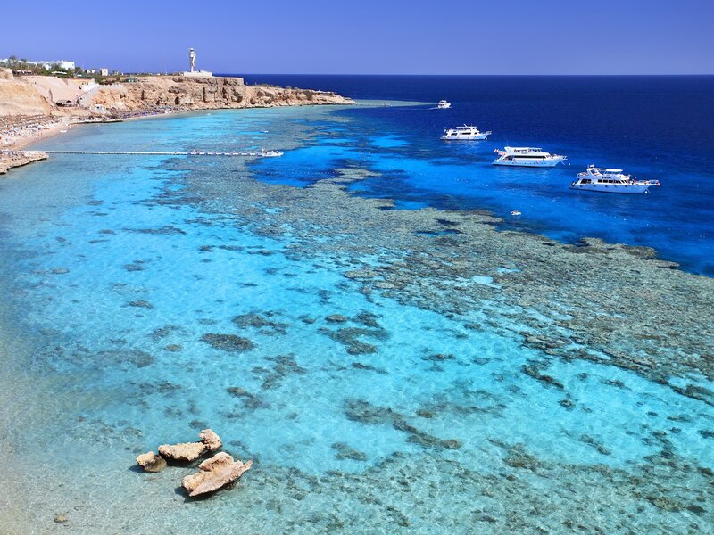 Coral reef beach with boats