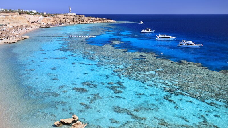 Coral reef beach with boats