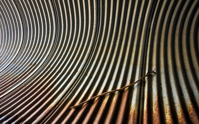Corrugated metal with a twig