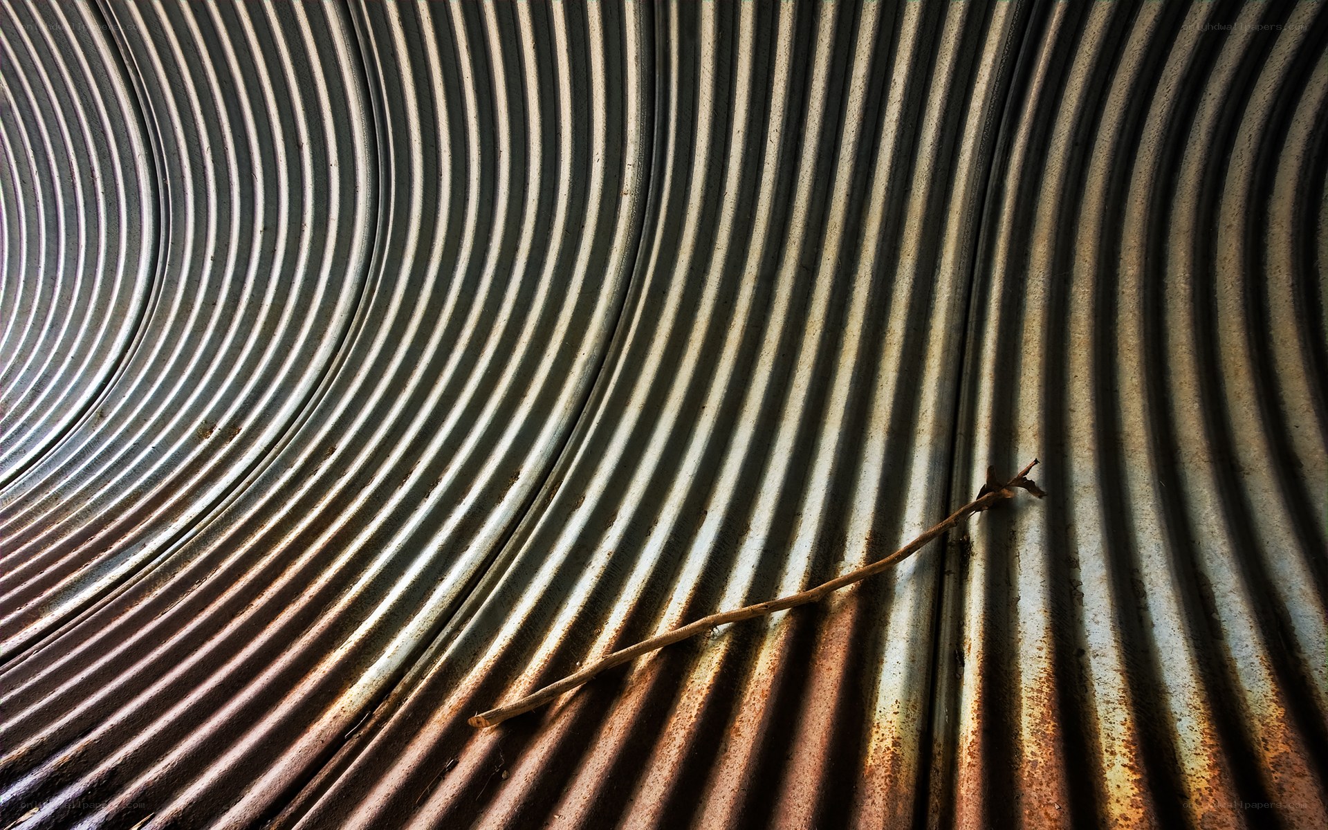 Corrugated metal with a twig