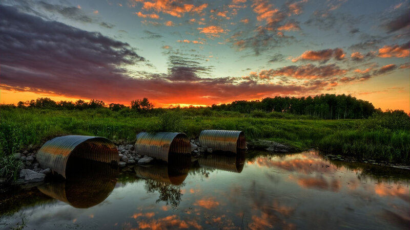 Corrugated Pipes in Stream — Orange, Dramatic, Sunset, Photograph, Sky, Trees