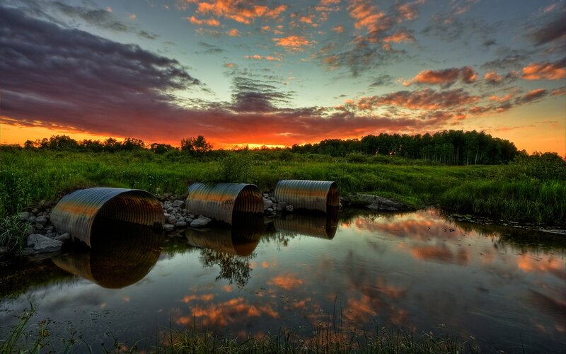 Corrugated Pipes in Stream — Orange, Dramatic, Sunset