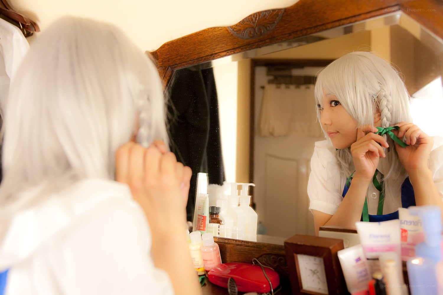 cosplayer adjusting hair in mirror
