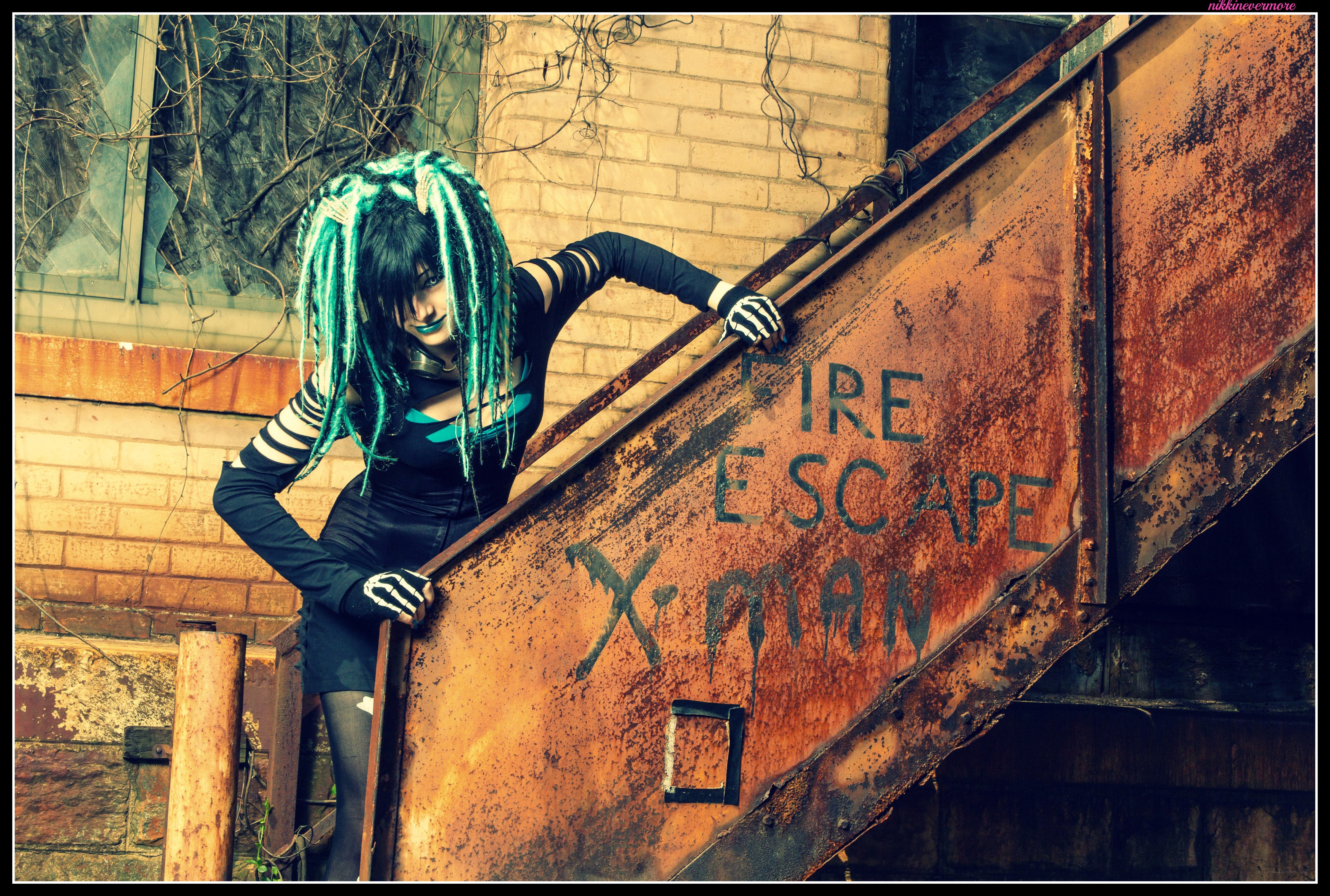 cosplayer by fire escape sign