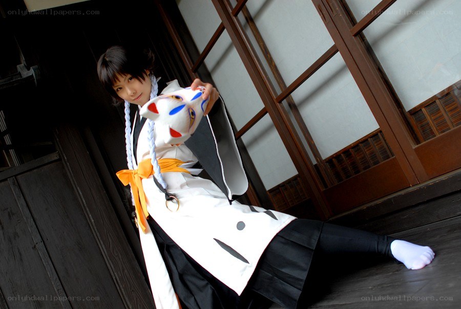 cosplayer holding a fox mask