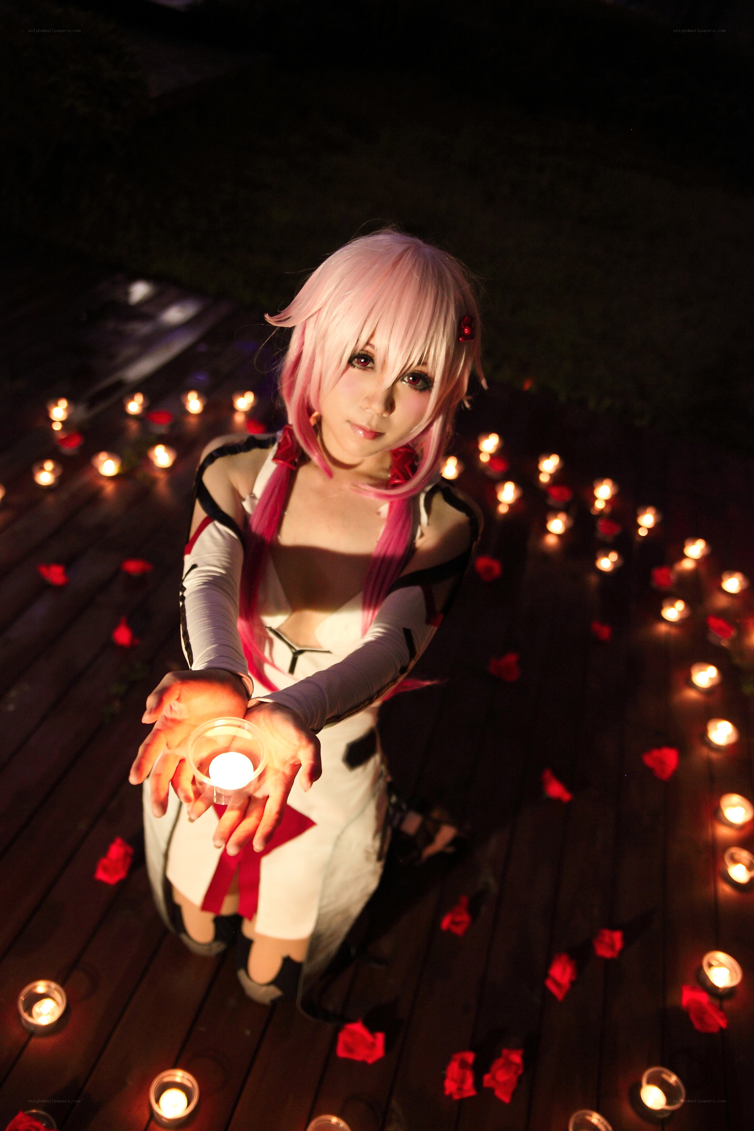 cosplayer holding candle at night