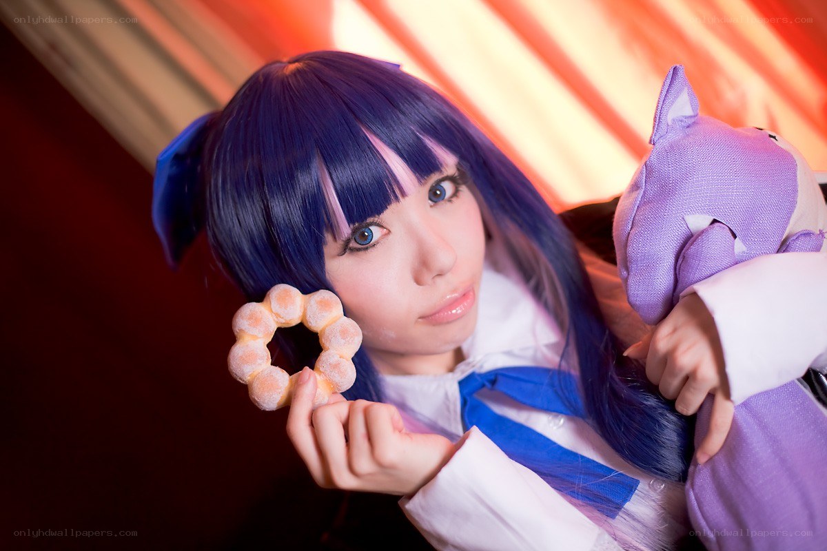 cosplayer holding donut and plush