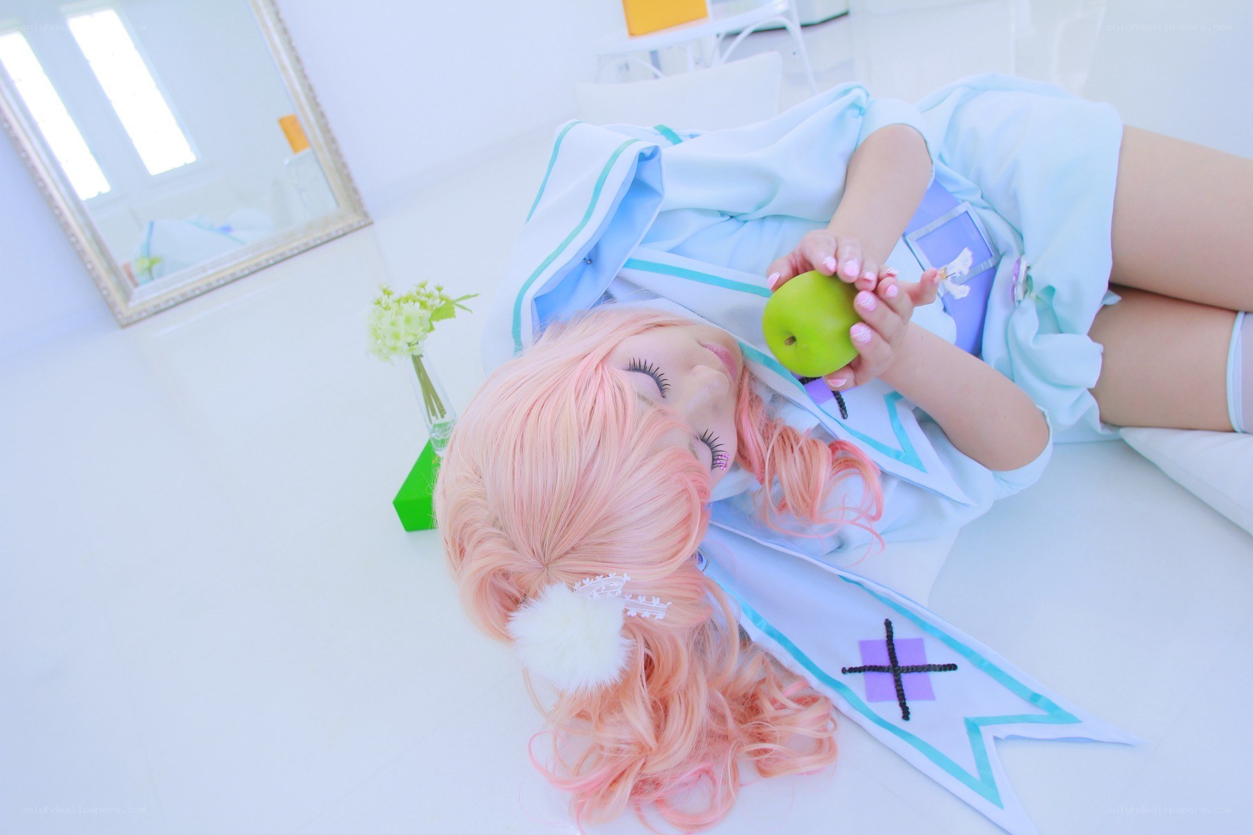 cosplayer holding green apple