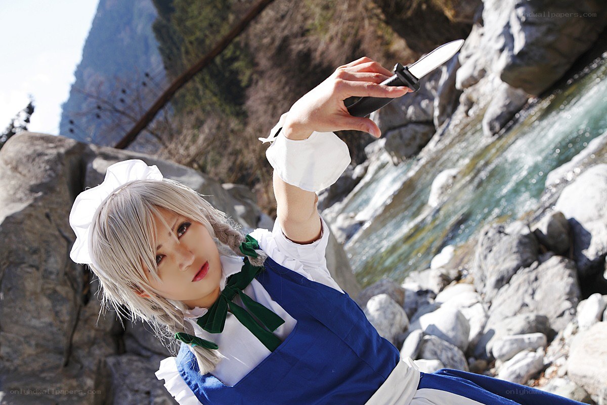 cosplayer holding knife near river