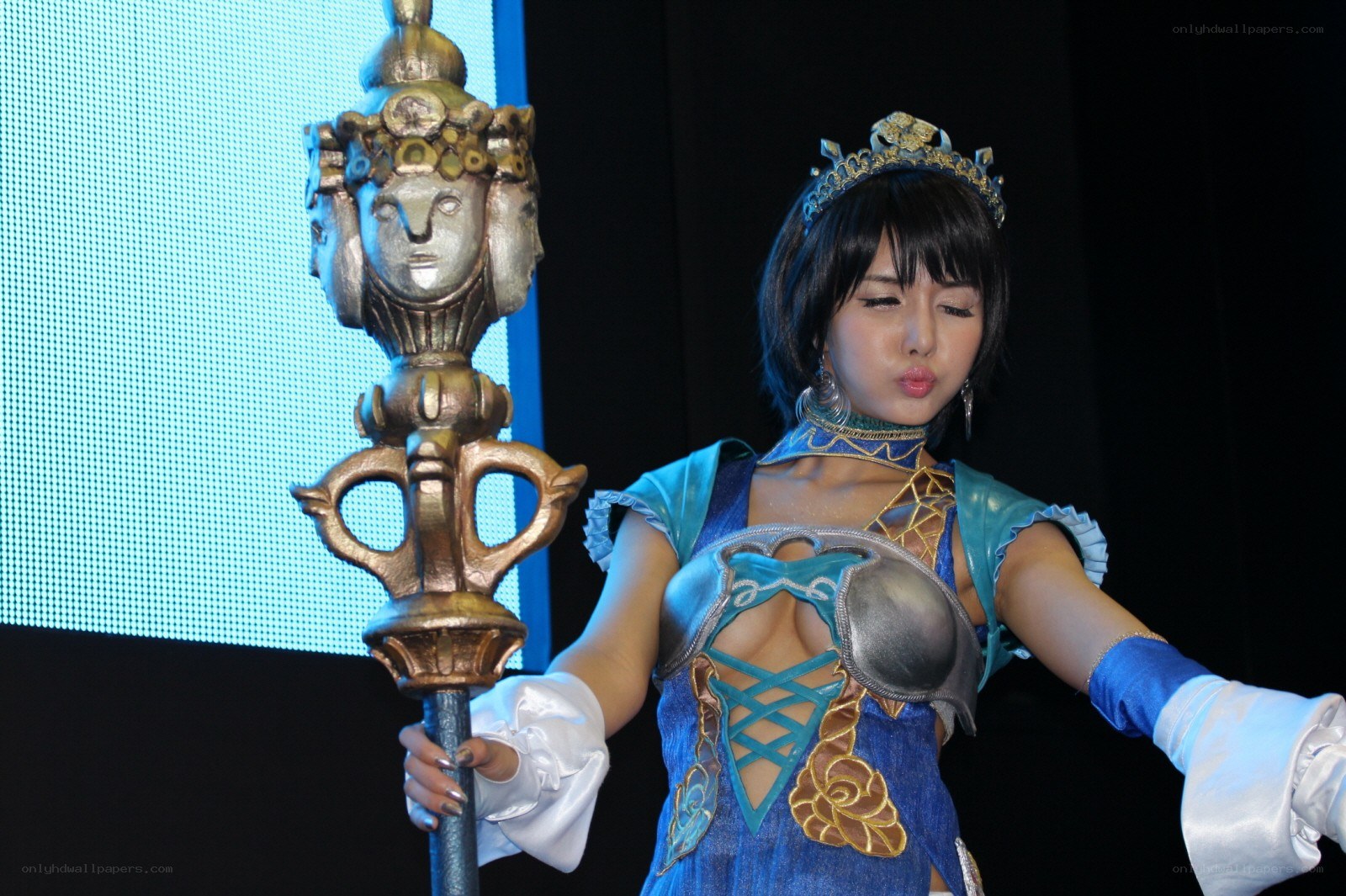 cosplayer holding ornate staff