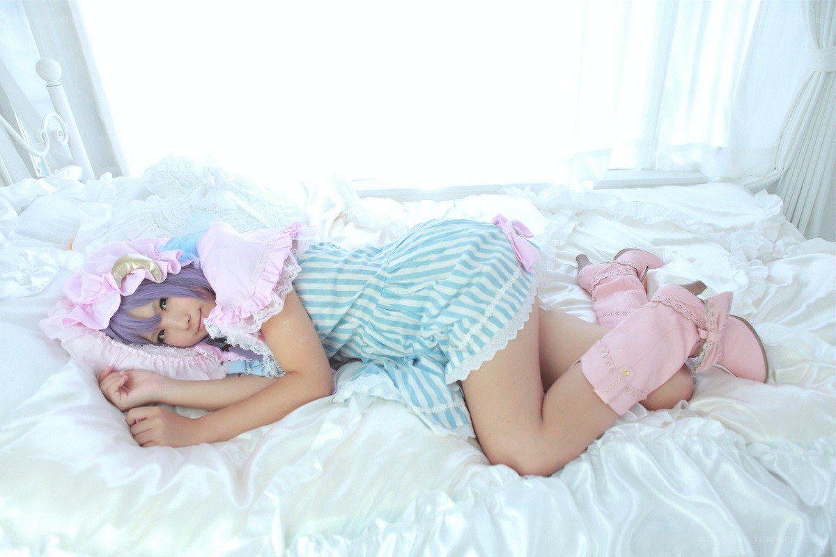 cosplayer in bed with pink outfit