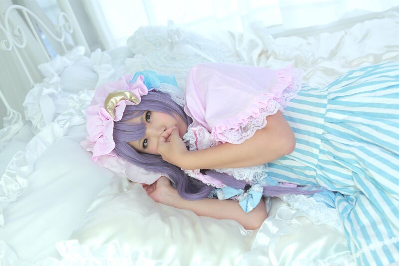 cosplayer in bed with purple hair